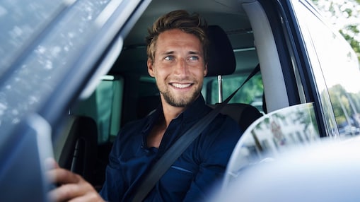 Man smiling in a car