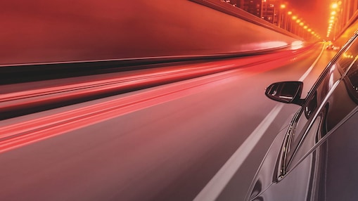 Side view of a car driving in the night