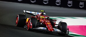 A red Scuderia Ferrari F1 car on a track with a distorted perspective to elongate the length of the track