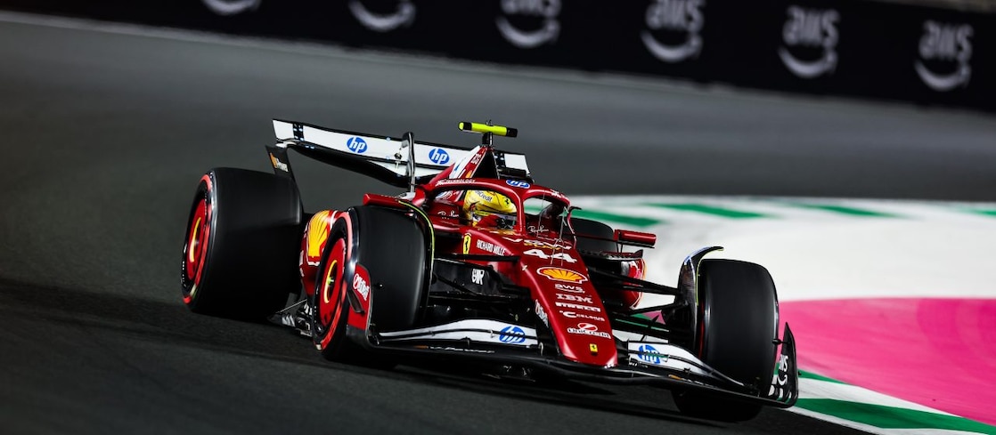 A red Scuderia Ferrari F1 car on a track with a distorted perspective to elongate the length of the track