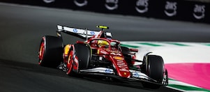 A red Scuderia Ferrari F1 car on a track with a distorted perspective to elongate the length of the track