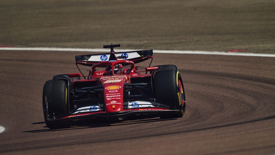 A red Scuderia Ferrari F1 car on a track with a distorted perspective to elongate the length of the track