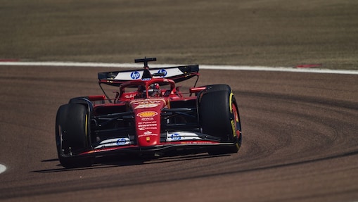 A red Scuderia Ferrari F1 car on a track with a distorted perspective to elongate the length of the track