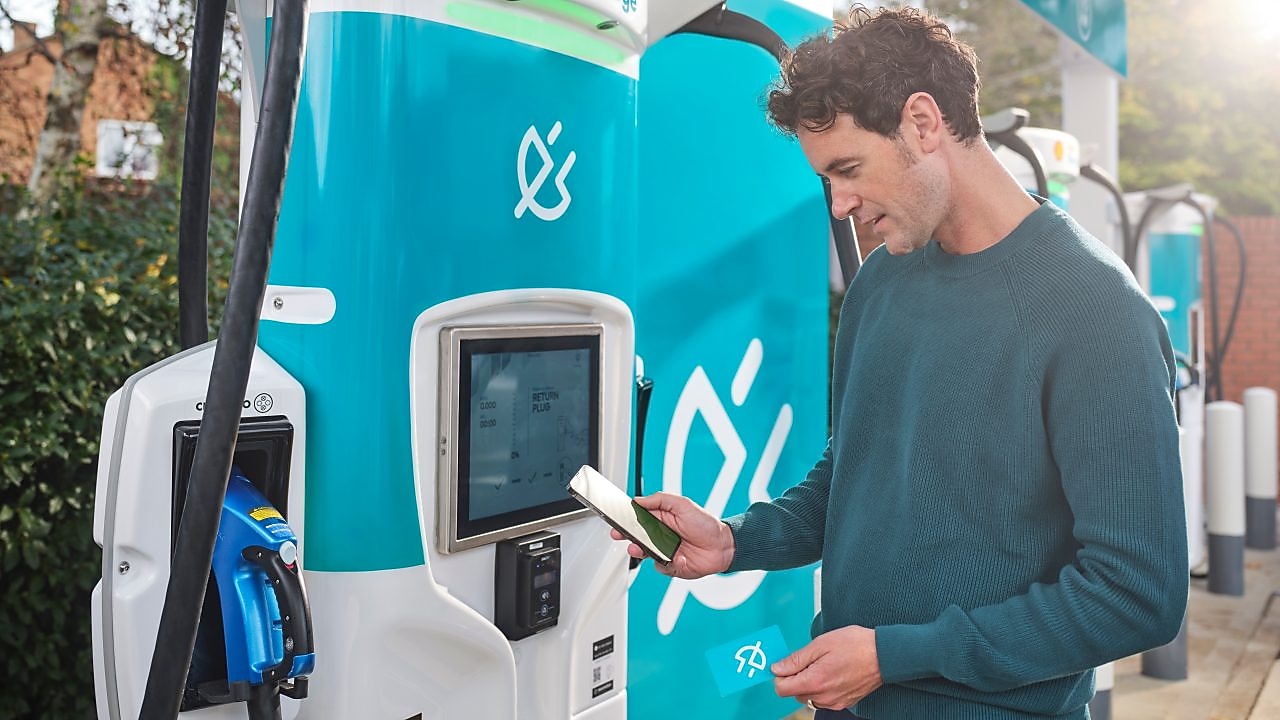Man using phone at a Shell Recharge Station