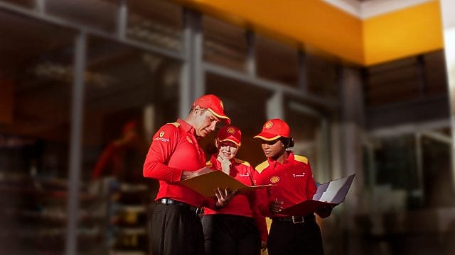 3 Shell employees discussing