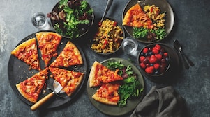 Slices of Pizza plated with salad.