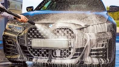 Close-up of a car headlight being scrubbed